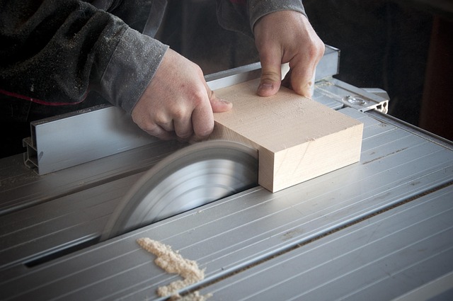 hands sanding natural wood toy parts in cozy woodworking workshop